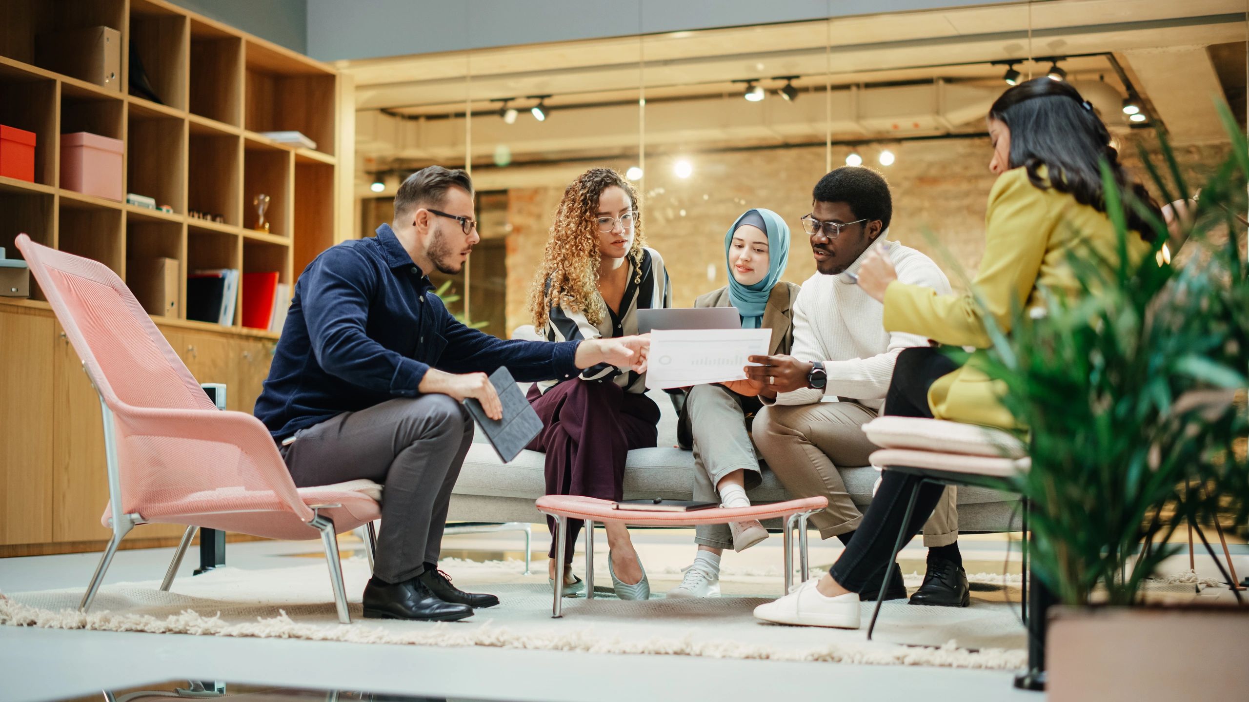 Team reviewing information together on a laptop in a meeting room